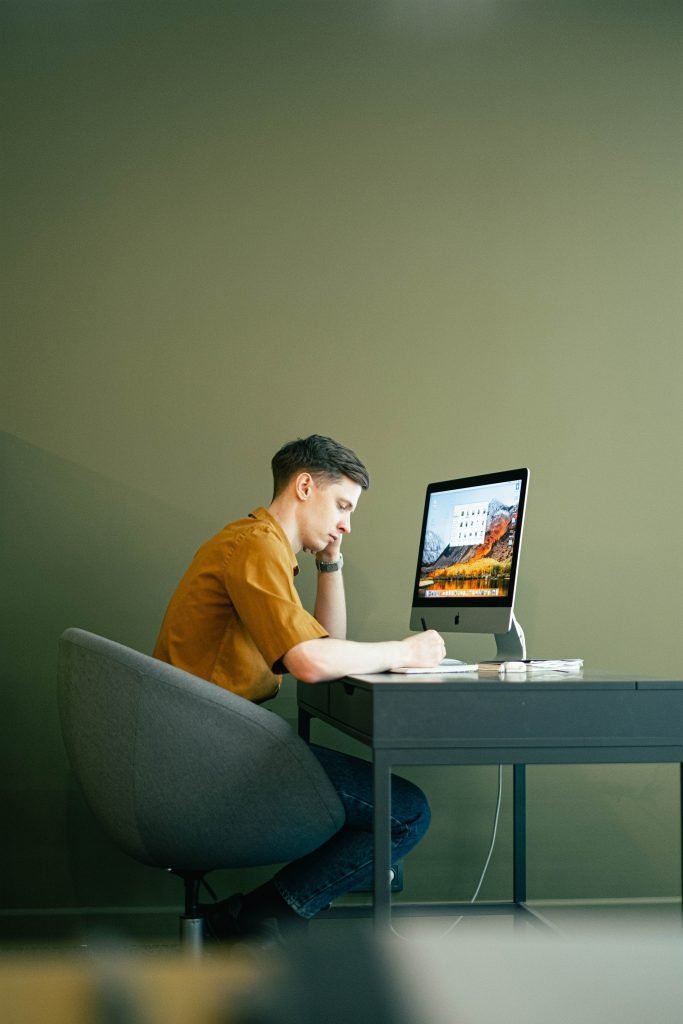 young man sitting at computer